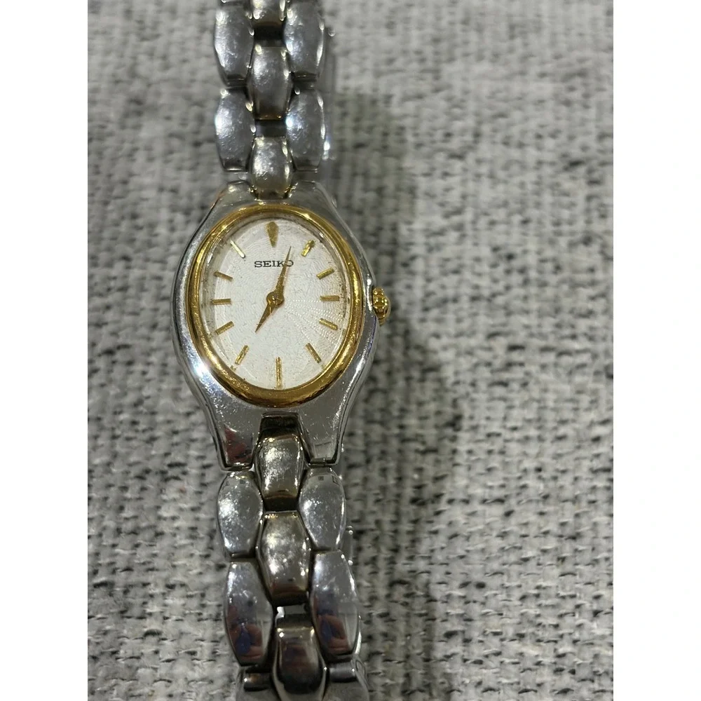Seiko Oval Women's Two Tone Silver and Gold Wrist  Sunburst Dial Watch 1N00-6F80